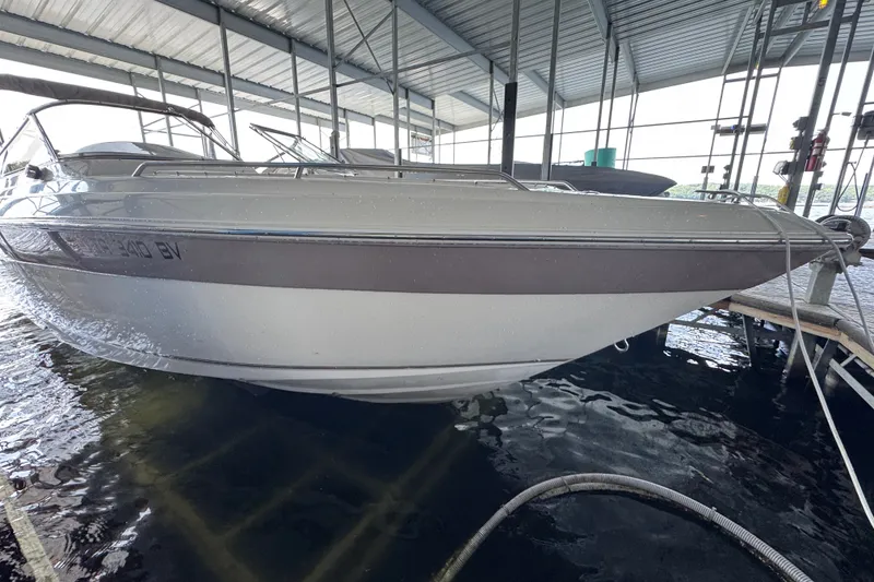 Slide: The Image of 2002 Regal 2900 LSR boat docked in covered marina, side view. - 4