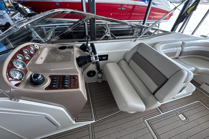 Slide: The Image of 2002 Regal 2900 LSR boat interior with steering wheel and seating. - 10