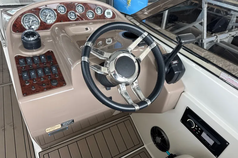 Slide: The Image of 2002 Regal 2900 LSR boat dashboard with steering wheel and control panel. - 11