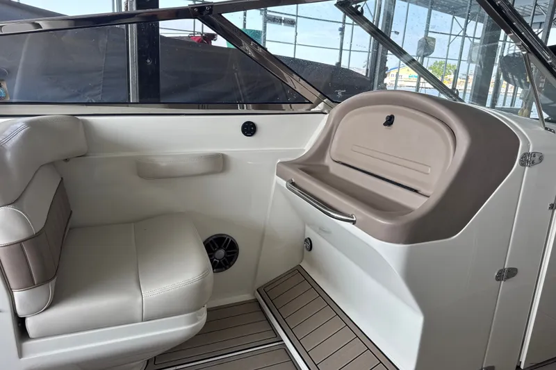 Slide: The Image of Interior of a 2002 Regal 2900 LSR boat, featuring seating and storage area. - 13