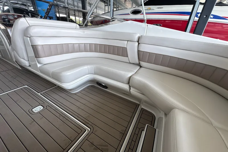 Slide: The Image of 2002 Regal 2900 LSR boat interior with beige seating and wooden flooring. - 18