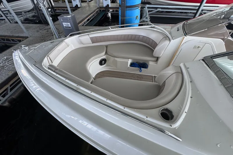 Slide: The Image of 2002 Regal 2900 LSR boat interior with seating and storage at a marina. - 35