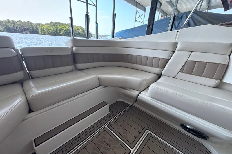Slide: The Image of Luxurious seating on a 2002 Regal 2900 LSR boat, overlooking a serene lake. - 17
