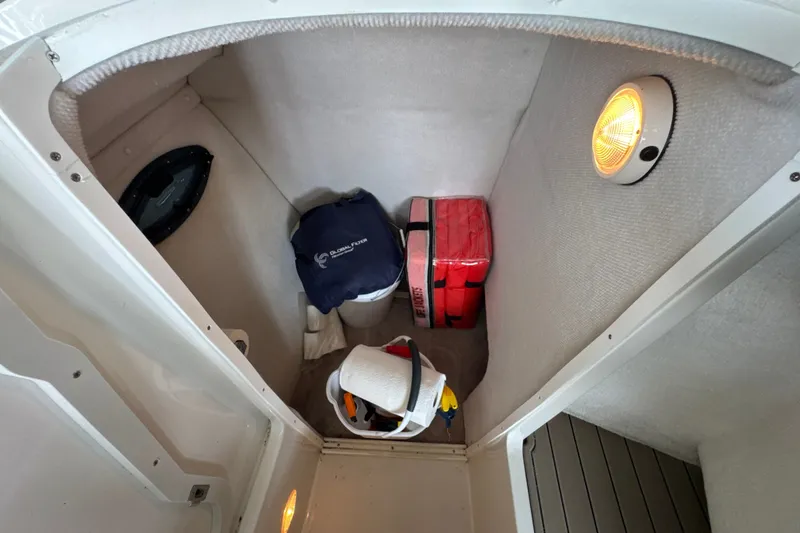 Slide: The Image of Interior storage compartment of a 2002 Regal 2900 LSR boat with safety equipment. - 38
