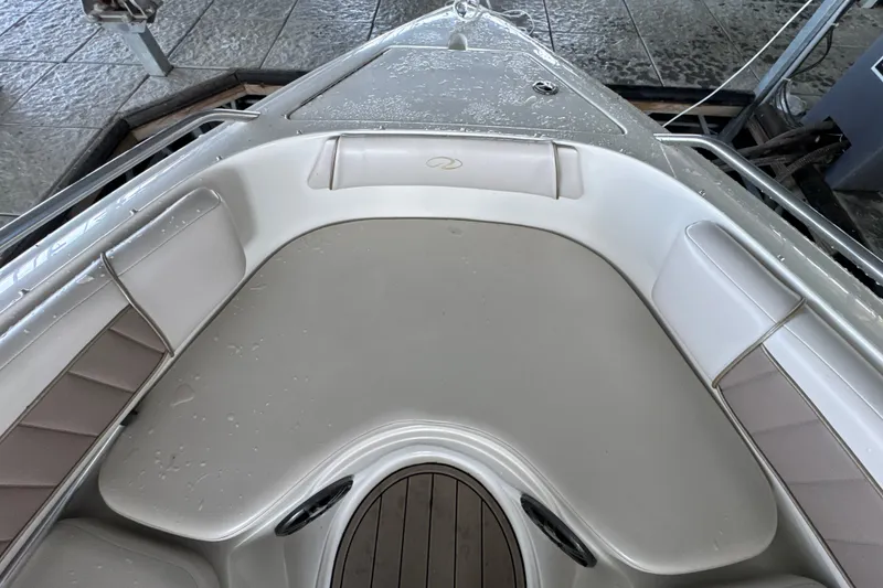 Slide: The Image of Bow seating area of a 2002 Regal 2900 LSR boat, featuring wet upholstery. - 26