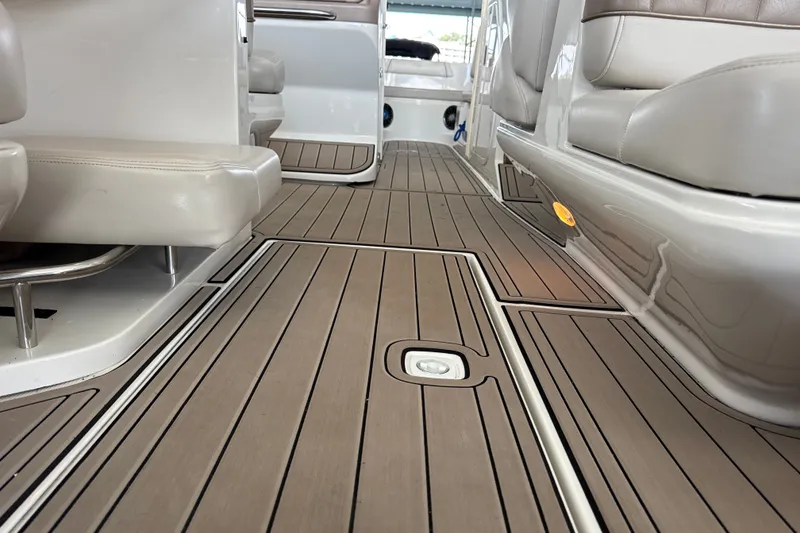 Slide: The Image of Interior view of a 2002 Regal 2900 LSR boat with sleek seating and wood-patterned flooring. - 22