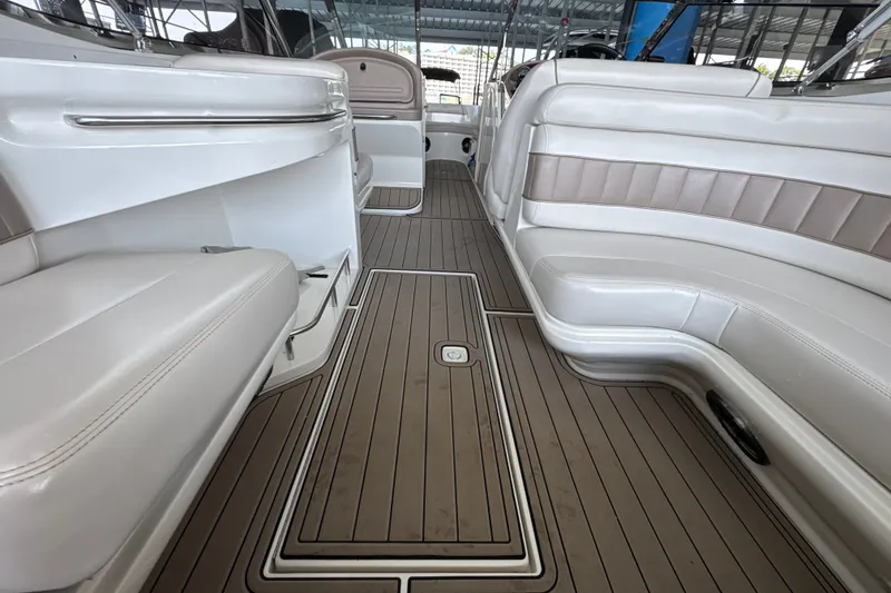 Slide: The Image of Interior of a 2002 Regal 2900 LSR boat with white seating and wood flooring. - 19