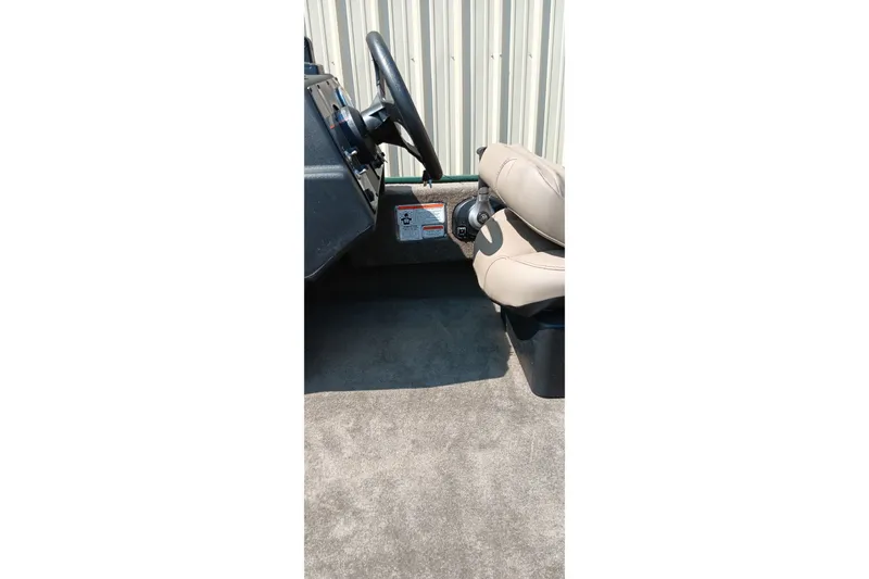Slide: The Image of Interior of 2026 Tracker Bass Tracker Classic Limited boat with steering wheel and seat. - 13