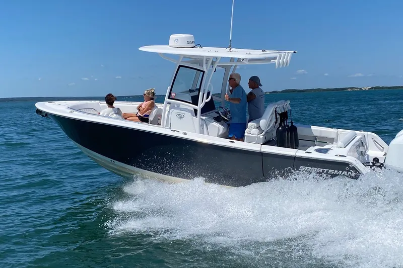 Slide: The Image of 2021 Sportsman Heritage 251 Center Console boat cruising on open water. - 4