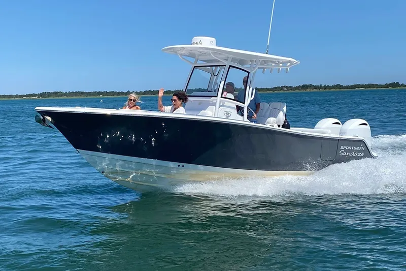 Slide: The Image of 2021 Sportsman Heritage 251 Center Console boat cruising on open water. - 0