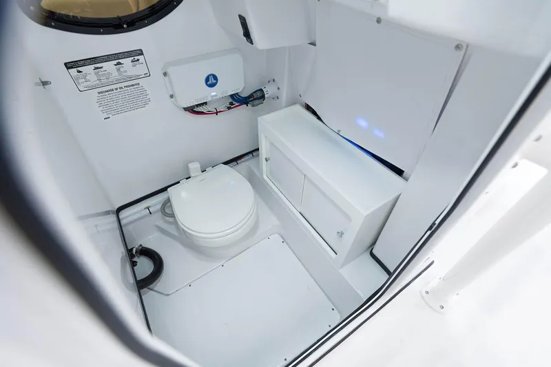 Slide: The Image of Manufacturer Provided Image: 2021 Sportsman Heritage 251 Center Console boat interior with toilet and storage. - 23