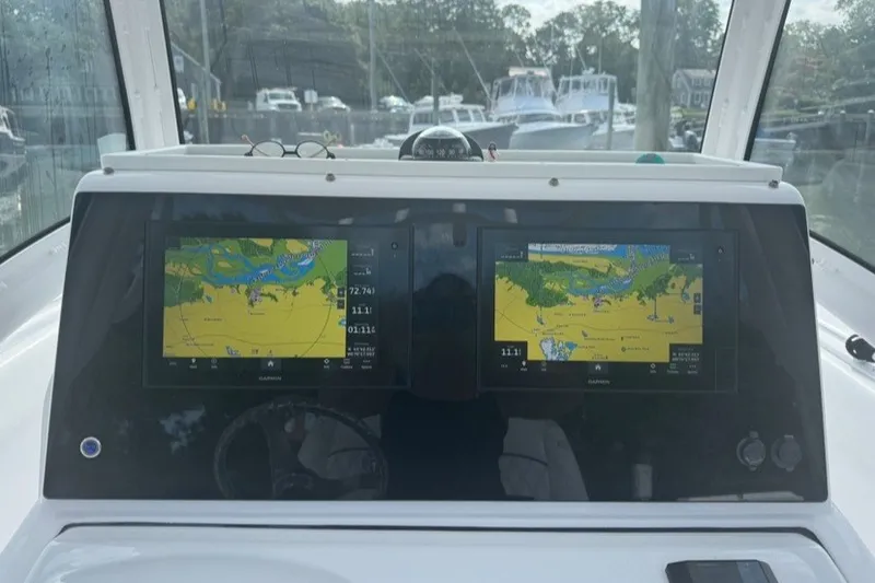 Slide: The Image of 2021 Sportsman Heritage 251 Center Console dashboard with dual Garmin navigation displays. - 11