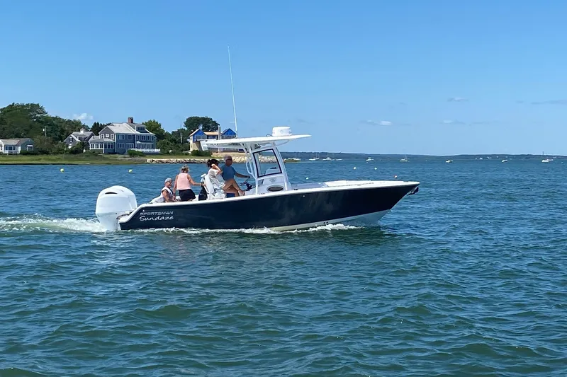 Slide: The Image of 2021 Sportsman Heritage 251 Center Console boat cruising on a sunny day. - 2