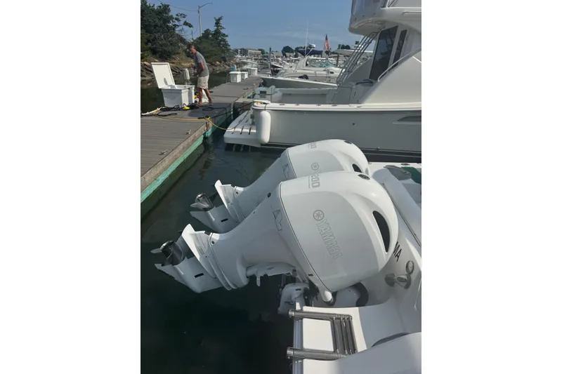 Slide: The Image of 2021 Sportsman Heritage 251 Center Console with twin Yamaha outboard motors docked at marina. - 8