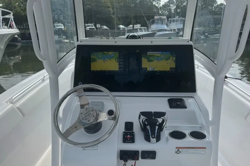 Slide: The Image of 2021 Sportsman Heritage 251 Center Console dashboard with navigation screens and steering wheel. - 10