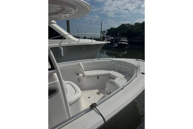 Slide: The Image of 2021 Sportsman Heritage 251 Center Console boat docked, featuring spacious seating area. - 18