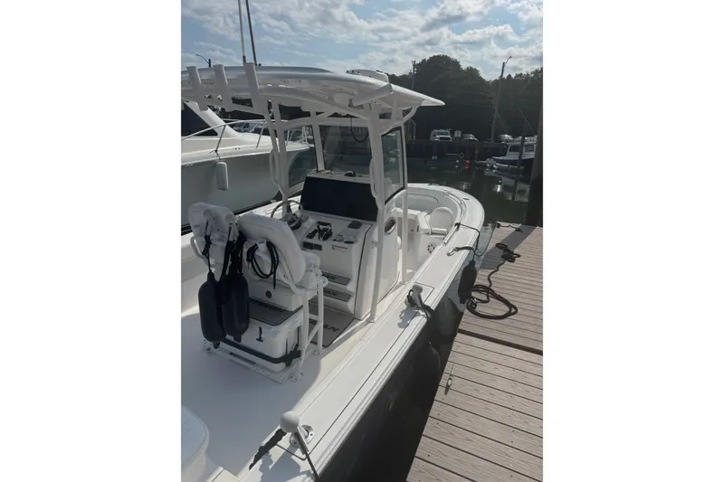 Slide: The Image of 2021 Sportsman Heritage 251 Center Console boat docked at marina. - 14