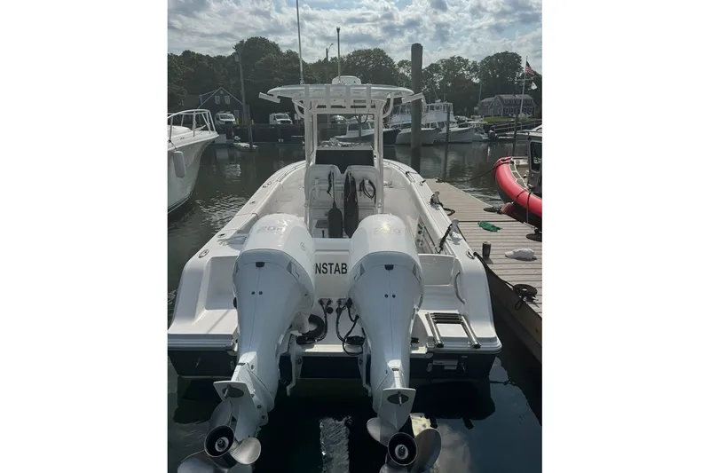 Slide: The Image of 2021 Sportsman Heritage 251 Center Console boat docked with twin engines. - 7