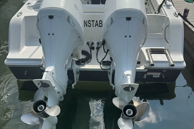 Slide: The Image of 2021 Sportsman Heritage 251 Center Console with dual outboard motors docked. - 9