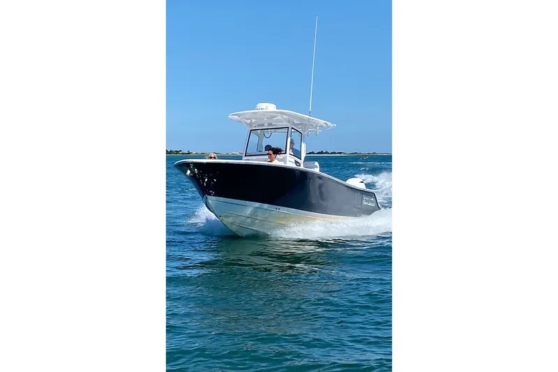 Slide: The Image of 2021 Sportsman Heritage 251 Center Console boat cruising on open water. - 24