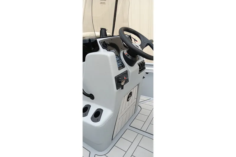 Slide: The Image of 2027 Tracker Bass Tracker Classic CC boat console with steering wheel and controls. - 13