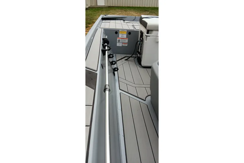Slide: The Image of 2027 Tracker Bass Tracker Classic CC boat interior with rod holders and seating. - 14