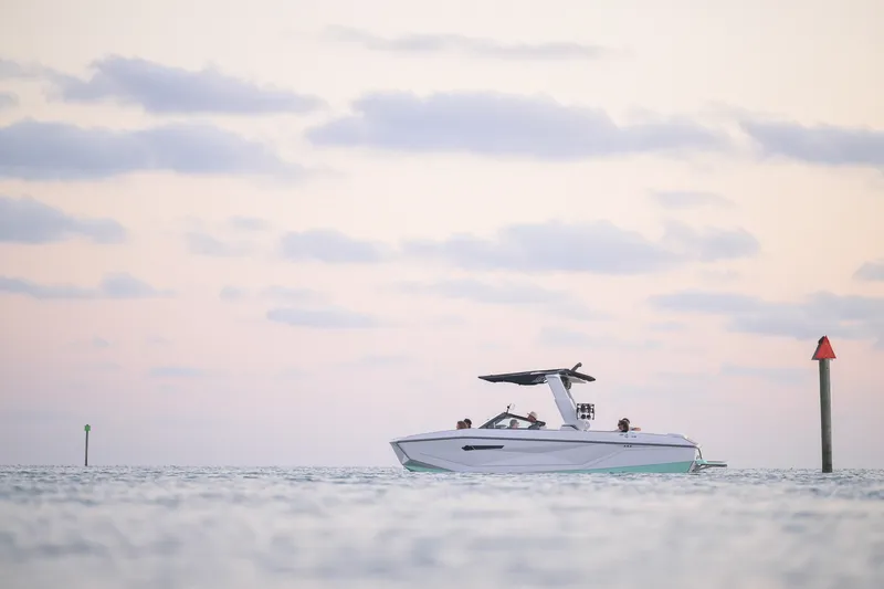 The Image of 2026 Nautique Super Air Nautique G25 Coastal Edition on calm water at sunset. - 3