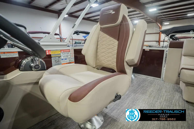 Slide: The Image of Captain's chair in a 2027 Bennington 22 SLJ pontoon boat, showroom setting. - 49