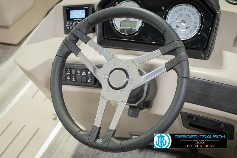 Slide: The Image of Steering wheel of 2027 Bennington 22 SLJ boat with dashboard controls. - 39