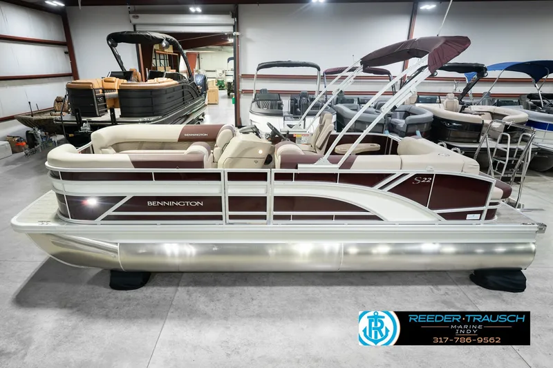 The Image of 2027 Bennington 22 SLJ pontoon boat in showroom, featuring sleek design and comfortable seating. - 0