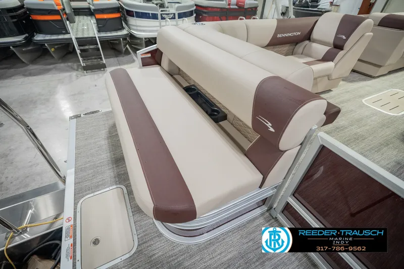 Slide: The Image of 2027 Bennington 22 SLJ pontoon boat interior with beige and brown seating in showroom. - 37