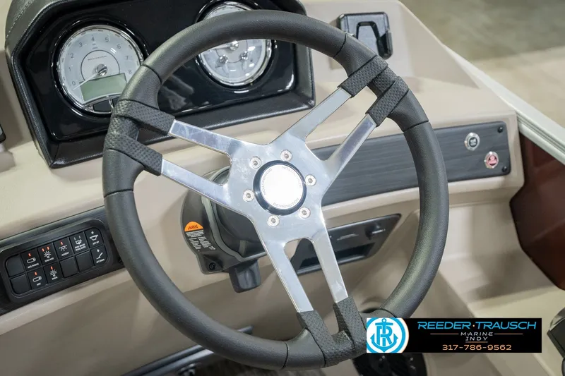 Slide: The Image of Steering wheel of a 2027 Bennington 22 SLJ boat with dashboard controls. - 40