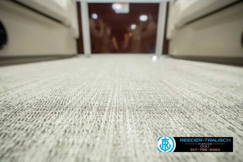 Slide: The Image of 2027 Bennington 22 SLJ boat interior flooring with Reeder-Trausch Marine logo. - 56