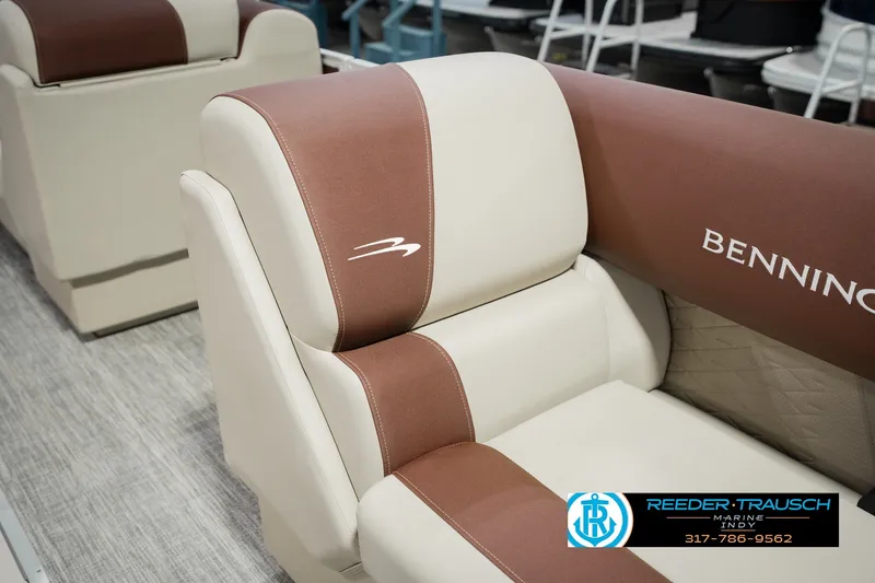 Slide: The Image of Luxurious seating on a 2027 Bennington 22 SLJ pontoon boat, featuring elegant brown and cream upholstery. - 28
