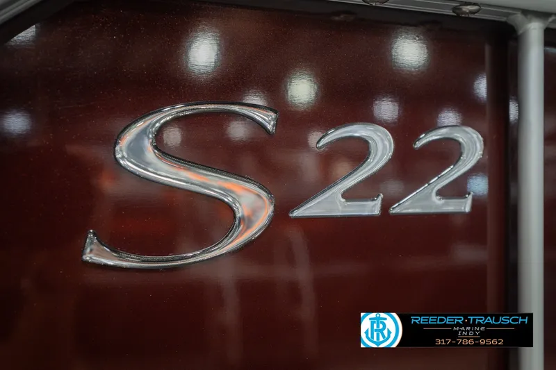 Slide: The Image of Close-up of 2027 Bennington 22 SLJ boat emblem with dealership logo. - 59