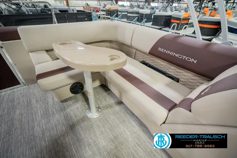 Slide: The Image of 2027 Bennington 22 SLJ boat interior with beige seating and table in showroom. - 33