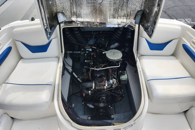 Slide: The Image of 2008 Bayliner 185 boat engine compartment with open hatch and seating. - 15