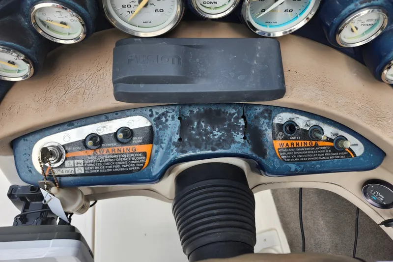 Slide: The Image of Dashboard of a 2008 Bayliner 185 boat with gauges and warning labels. - 29