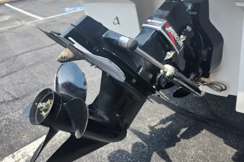 Slide: The Image of 2008 Bayliner 185 boat with Mercury outboard motor and propeller in parking lot. - 6