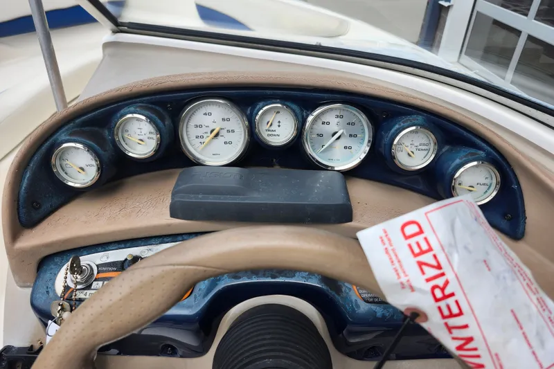 Slide: The Image of Dashboard of a 2008 Bayliner 185 boat with gauges and winterized tag. - 28
