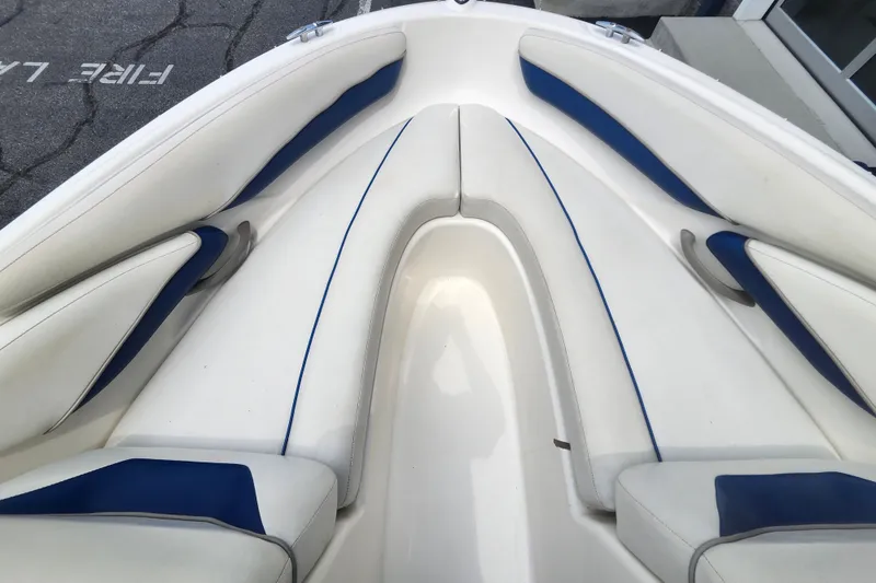 Slide: The Image of Interior view of a 2008 Bayliner 185 boat with white and blue seating. - 32