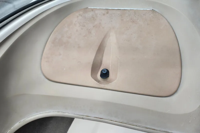 Slide: The Image of Interior detail of a 2008 Bayliner 185 boat, featuring a beige panel with a black knob. - 24