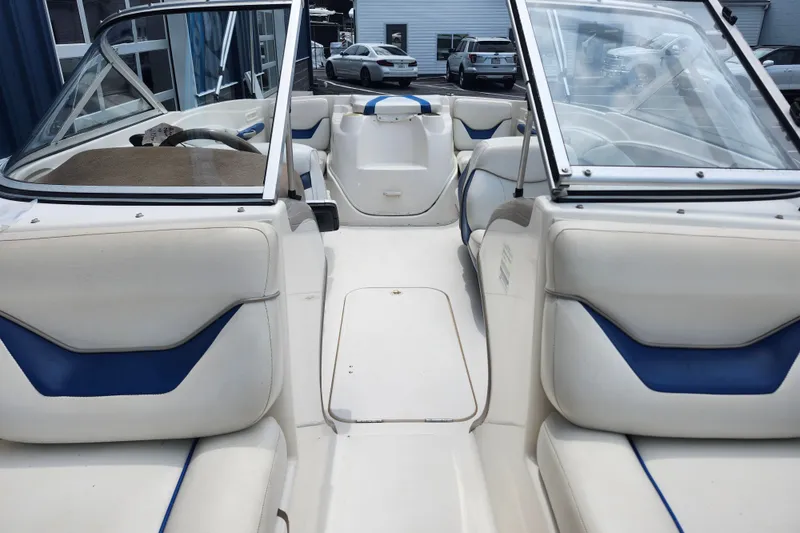 Slide: The Image of Interior of a 2008 Bayliner 185 boat with white and blue seating. - 33