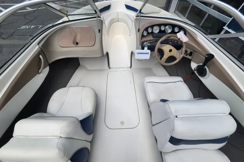 Slide: The Image of 2008 Bayliner 185 boat interior with white seating and steering console. - 12