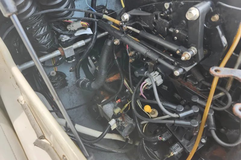 Slide: The Image of Engine compartment of a 2008 Bayliner 185 boat, showing various mechanical components and wiring. - 18