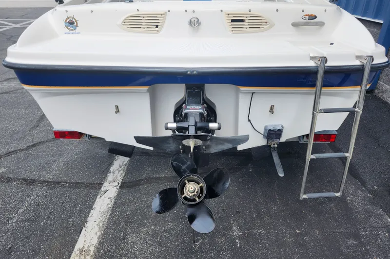 Slide: The Image of 2008 Bayliner 185 boat stern with propeller and ladder in parking lot. - 10