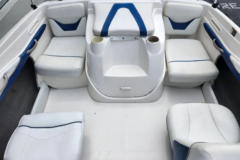 Slide: The Image of Interior of a 2008 Bayliner 185 boat with white and blue seating. - 13