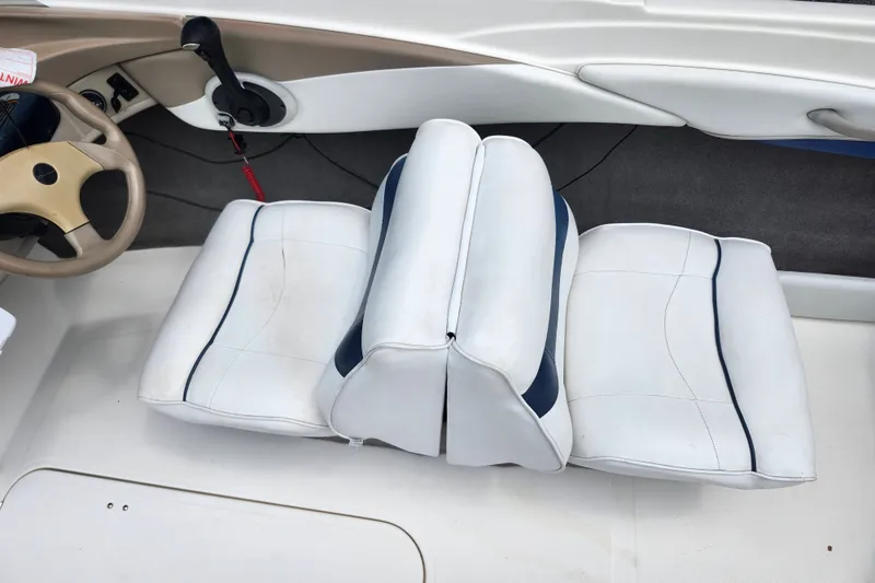 Slide: The Image of 2008 Bayliner 185 boat interior with white seating and steering wheel. - 26