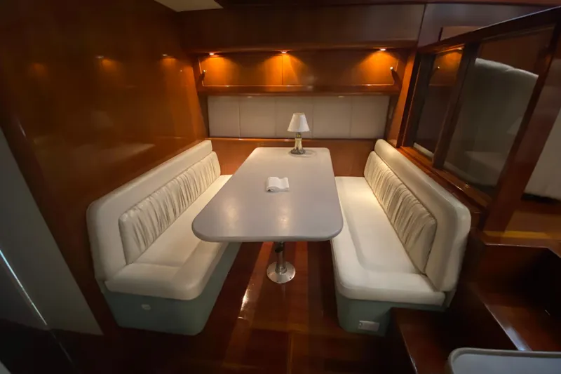 Slide: The Image of Luxurious dining area in a 1995 Silverton 41 Convertible yacht with elegant lighting. - 15