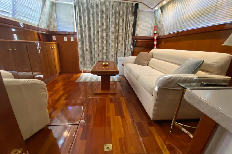 Slide: The Image of Luxurious interior of a 1995 Silverton 41 Convertible yacht with polished wood flooring. - 10